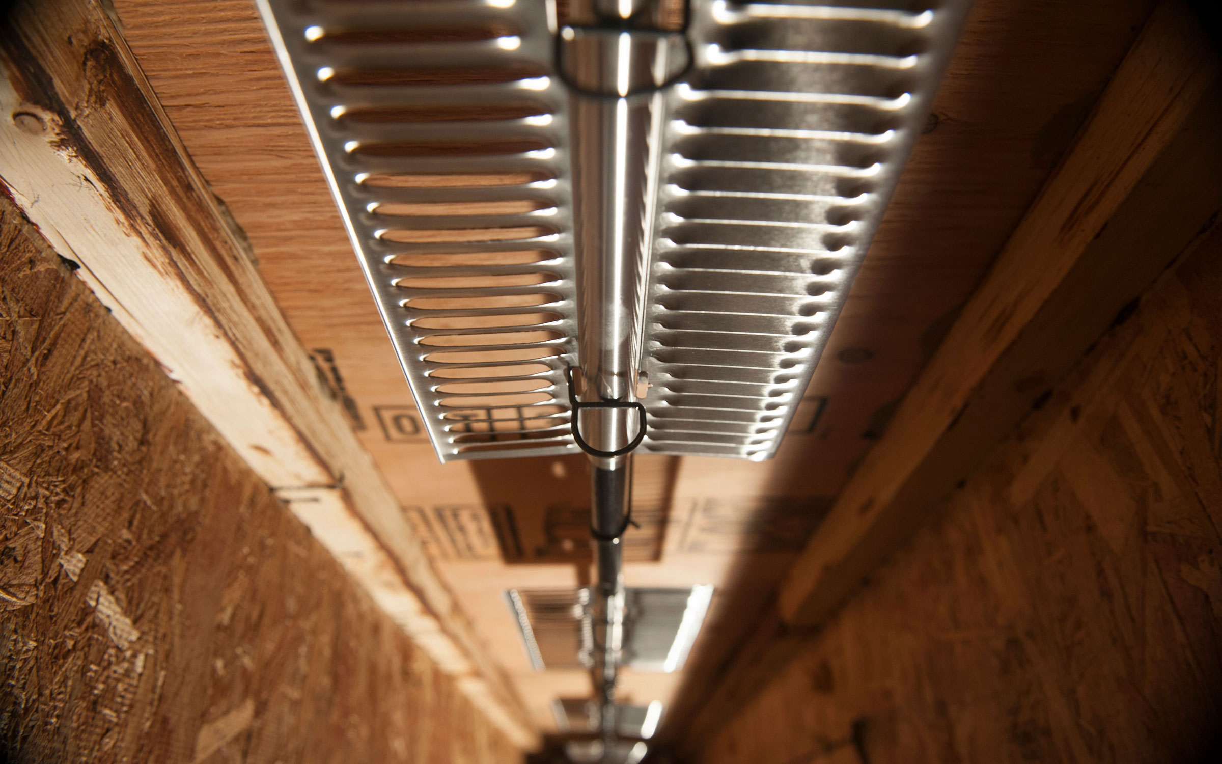 Ultra-Fin aluminum fin plates on hydronic tubing — close-up